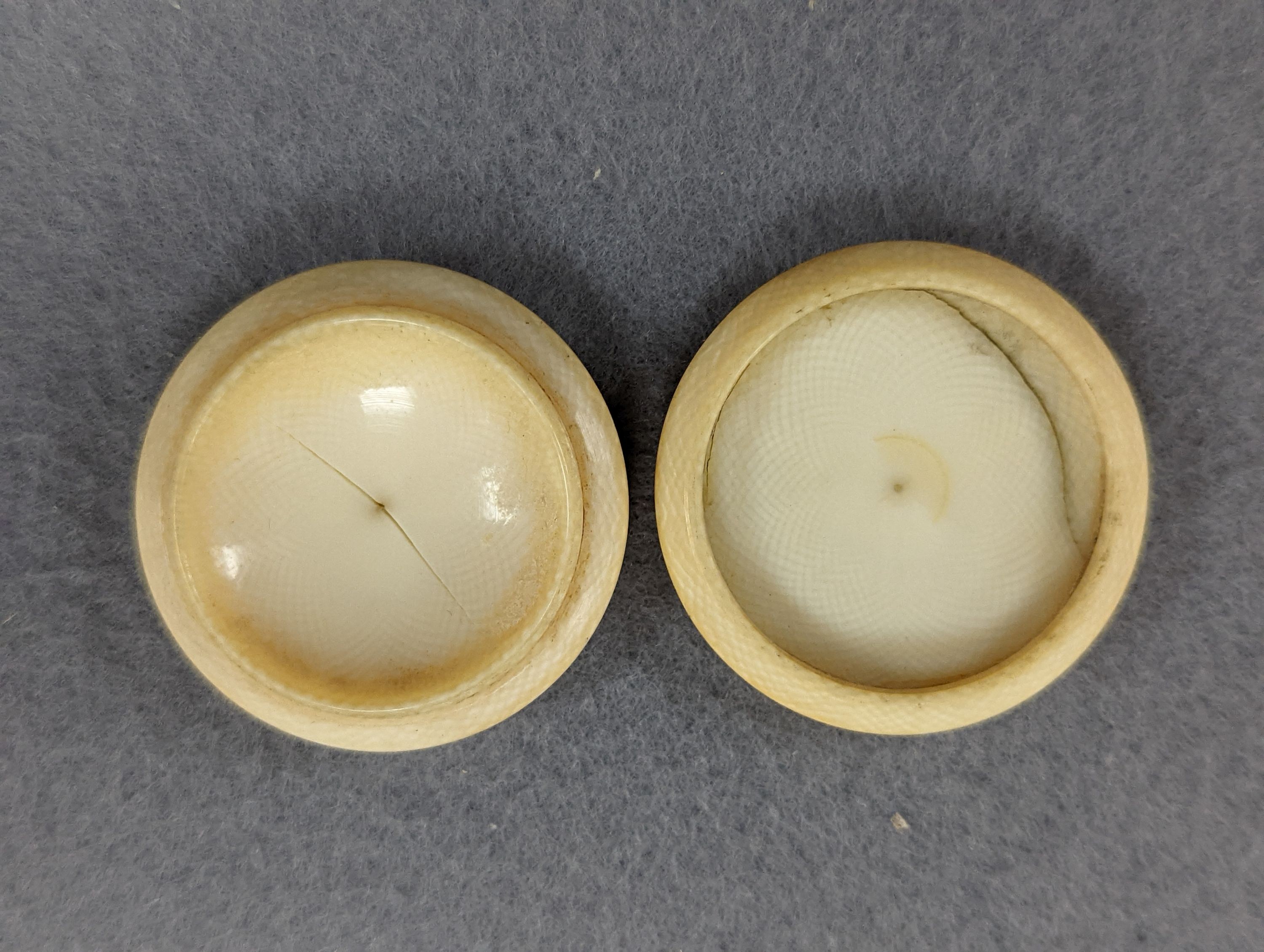 A pair of 19th century ivory balm pots, 3.75cm., a smallDieppe triptych figure, 6.5cm. a Meiji tiger brooch and a Dutch page marker.